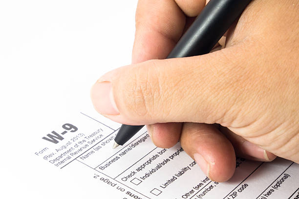 istock Tax form W-9 and pen 508938005