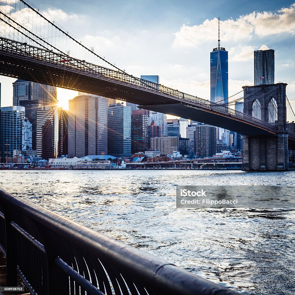 Brooklyn Bridge i Manhattan o zachodzie słońca - Zbiór zdjęć royalty-free (Rzeka)