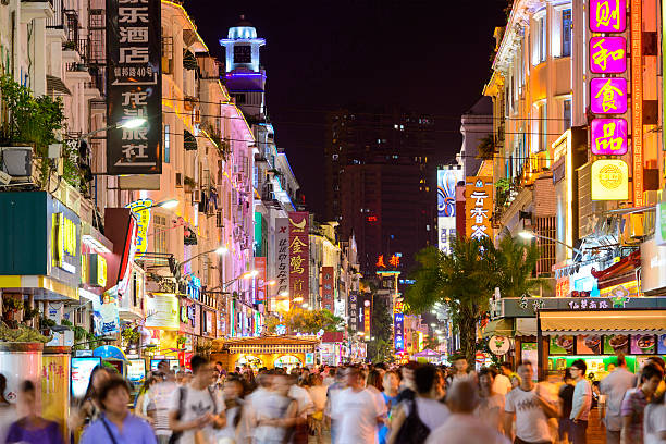 Xiamen, China - June 11, 2014: Pedestrians walk on Zhongshan Road at night. The road is the main commercial street in Xiamen and parts have been fully pedestrianized.