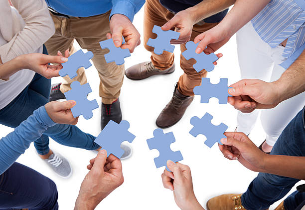 istock Group of people connecting puzzle pieces 508939441
