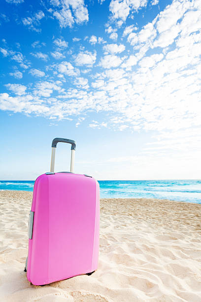 istock Pink suitcase on the beach 508939464