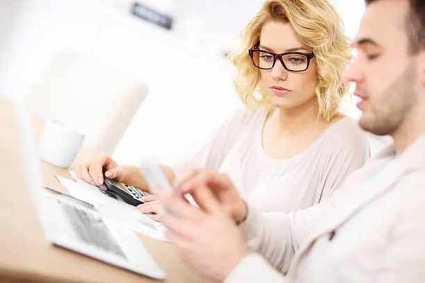 Photo of Unhappy couple with documents at home