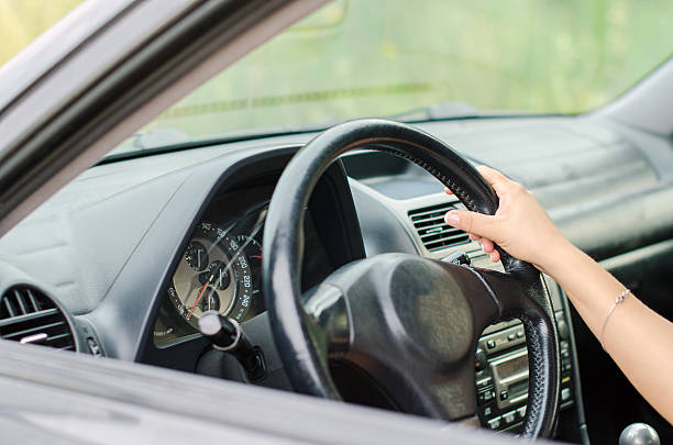 istock Woman's hand driving a car. Unrecognizable person. 508939835