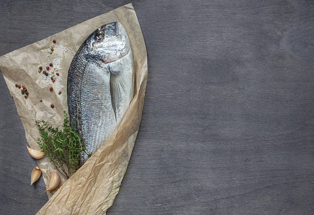 istock Dorado fish on wooden background 508940590