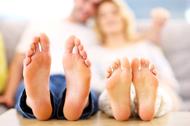 istock Barefeet of a happy couple lying on  sofa 508940974
