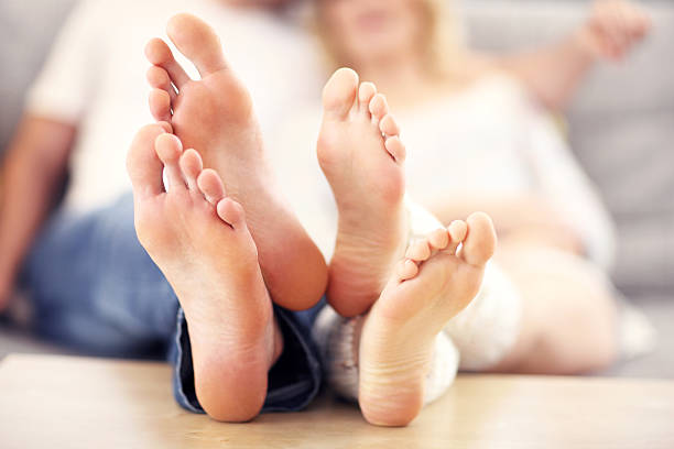 istock Barefeet of a happy couple lying on  sofa 508941324