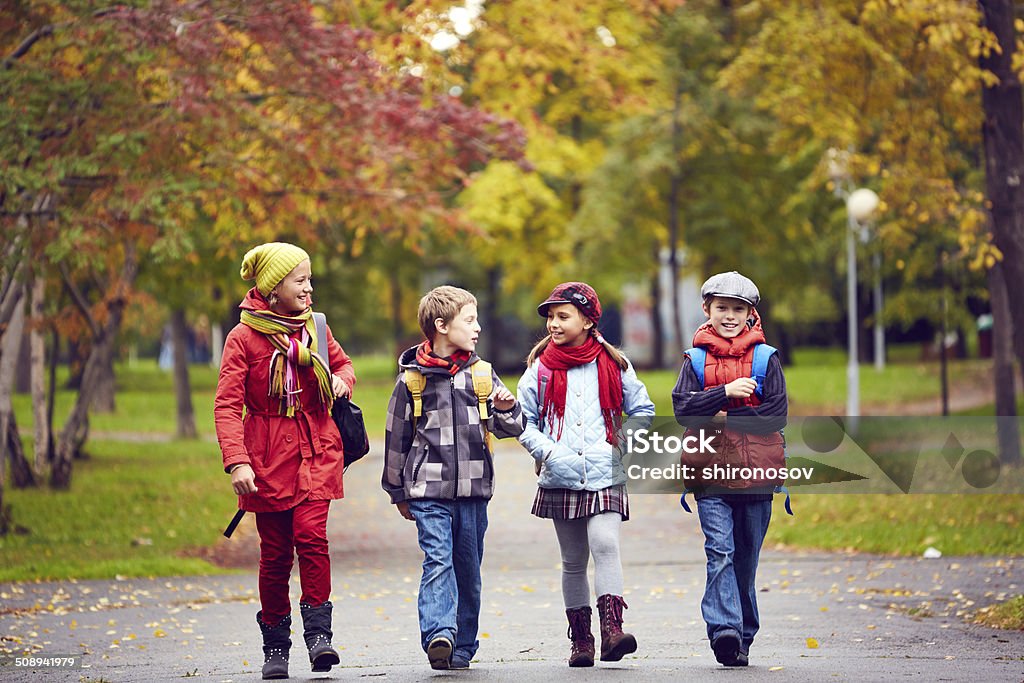 Schoolchildren Portrait of happy schoolkids talking while going to school Child Stock Photo