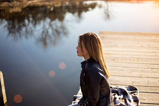 istock Young woman relaxes on lake 508942450