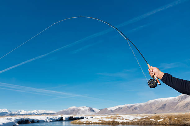 Close Up POV of a Fly Fishing Reel And Rod A Close Up, POV of a Fly Fishing Reel And Rod after casting upstream of the river. owens river stock pictures, royalty-free photos & images