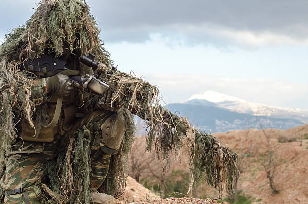 Ghillie suit sniper snow mountain background