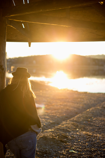 Woman Looking Sunset at Lake