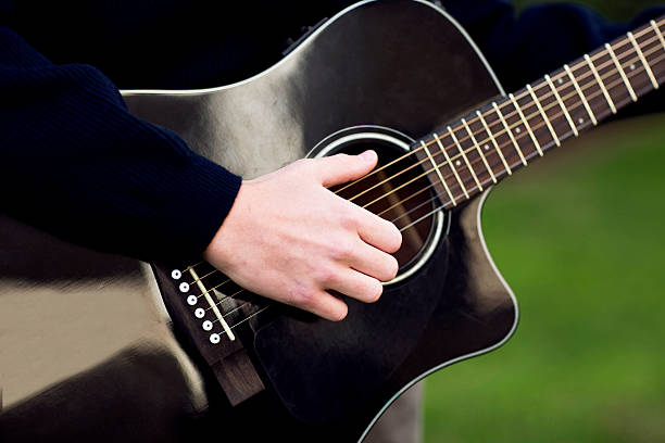 istock Guitar player playing song outdoor 508943570