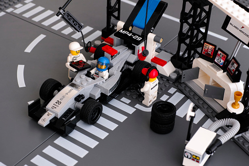 Tambov, Russian Federation - June 24, 2015: Lego MP4-29 race car in McLaren Mercedes Pit Stop by LEGO Speed Champions with fully equipped convertible pit stop with crew. Studio shot.