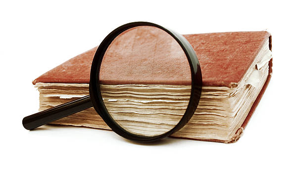 istock Magnifying glass near with antique book 508945634
