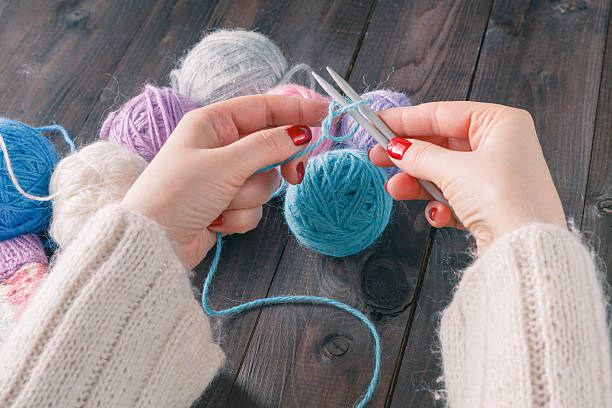 istock Close-up of hands knitting 508947558