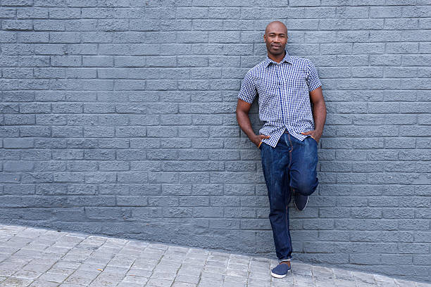 istock Relaxed african american man leaning against wall 508952598