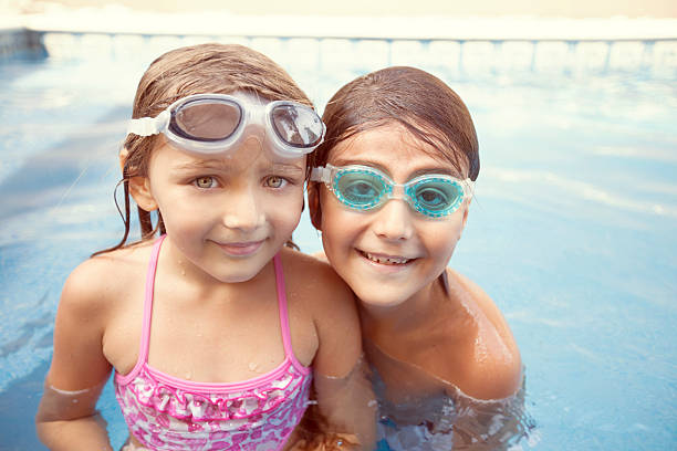 istock Happy kids in swimming pool 508953970