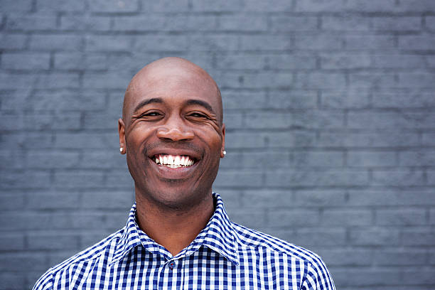 istock Smiling african man standing against a gray wall 508955010