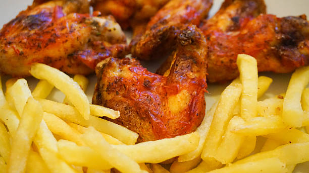 Peri Peri Chicken Wings And Chips stock photo