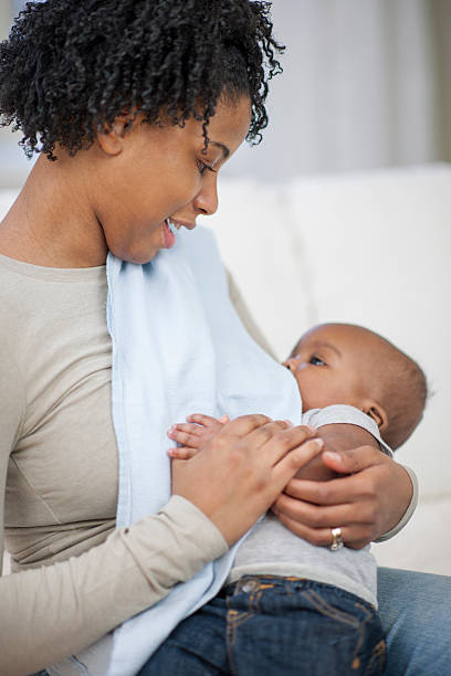 Ethnic mother breast feeding her baby boy.