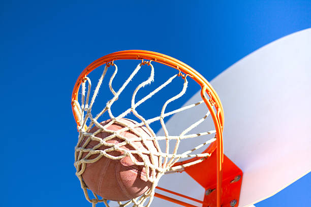 istock Scoring: Basketball Falling Through Hoop; Indigo Sky (Close-Up) 508958196