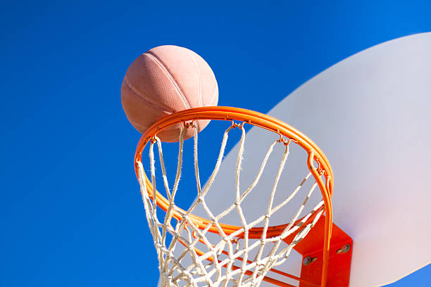 istock Scoring: Basketball Headed into Hoop Against an Indigo Sky (Close-Up) 508958304