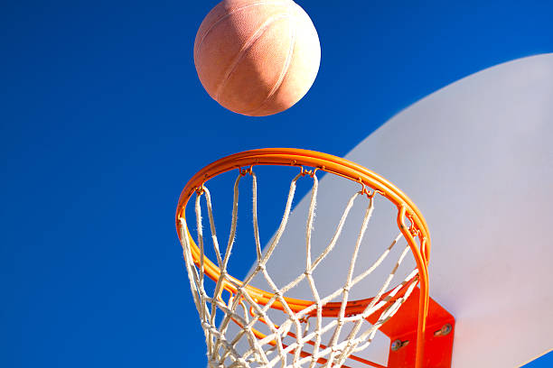 istock Scoring: Basketball Heading into Hoop, Indigo Sky (Close-Up) 508958350