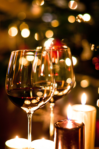 Wine glasses with Christmas tree in background