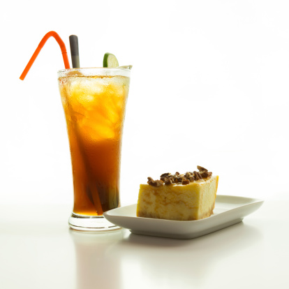 Close up of cheese cake with walnut topping and iced lemon tea