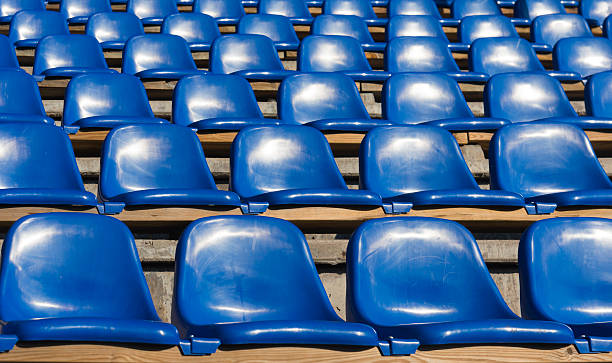 istock empty blue seats at sports stadium 508962301