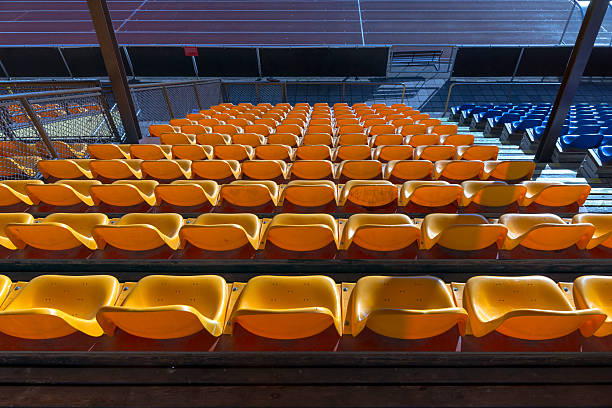 istock empty yellow seats at sports stadium 508963301