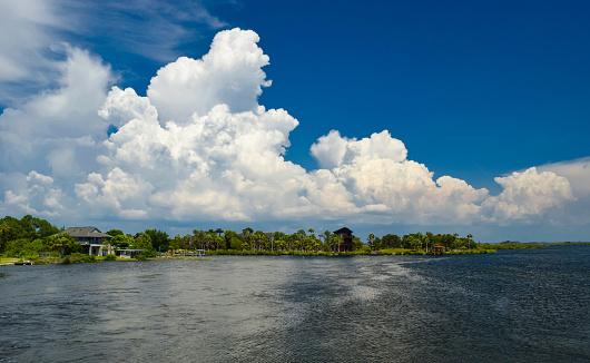 Thunderclouds rise against a blue sky over Ozello Keys near Crystal River, Florida.