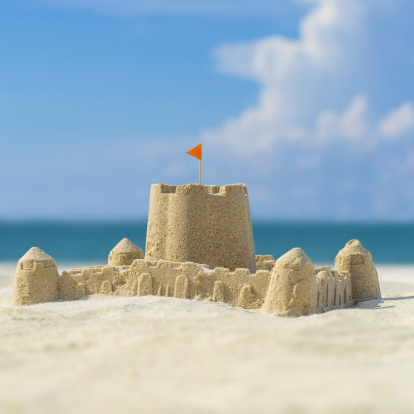 Children’s toys and Builded sand castle  structure on the beach
