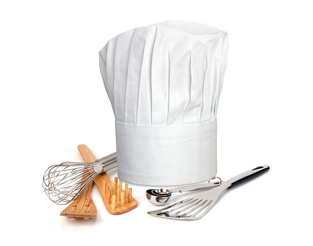 Chef Hat and utensils A chefs hat and utensils on a white background toque stock pictures, royalty-free photos & images