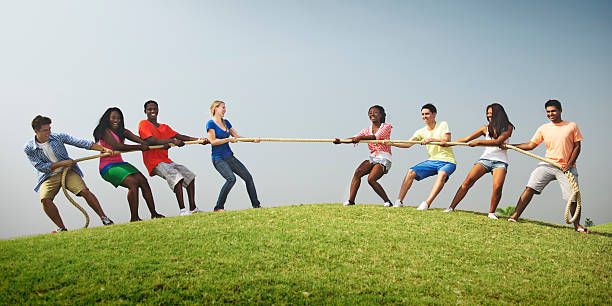 istock Group Casual People Playing Tug War Concept 508967880