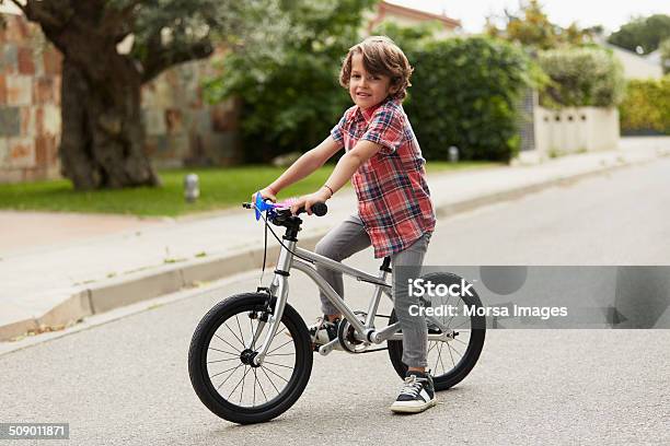 Confident Boy Sitting On Bicycle Stock Photo - Download Image Now - Child, Cycling, Bicycle