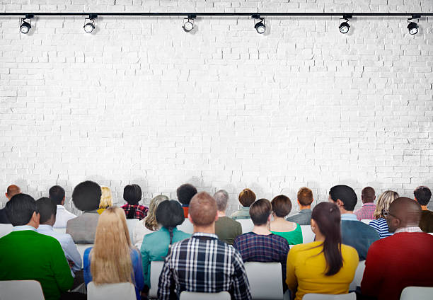istock Group of Diverse People Facing White Brick Wall 509026354