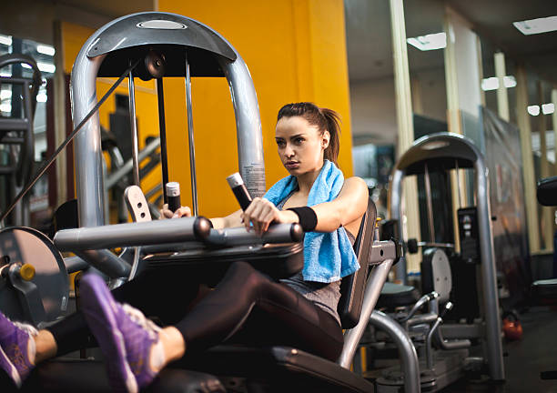 istock Woman exercising on leg press in gym 509027346