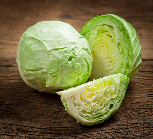 cabbage and cutted cabbage on wooden