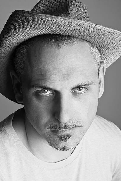 istock Man in a cowboy hat a weary expression on his face 509028882