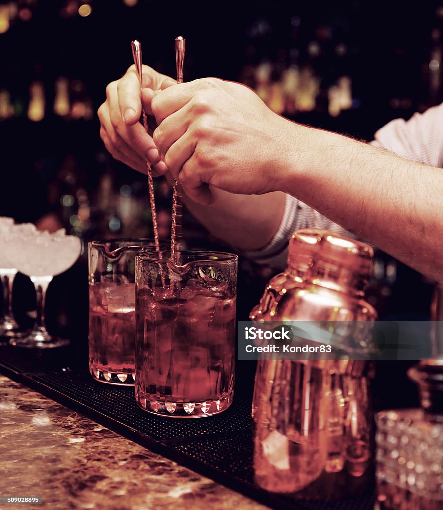 Bartender is stirring cocktails Bartender is stirring cocktails in mixing glasses Bar - Drink Establishment Stock Photo