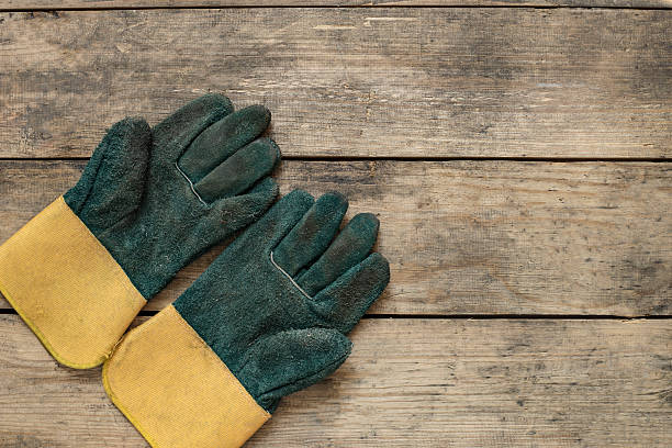 istock old dirty leather work gloves on wood background 509029054