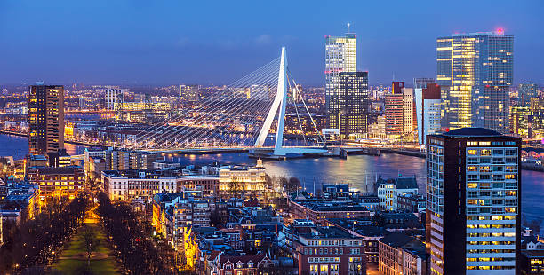 Rotterdam Skyline Aerial shot of Rotterdam skyline with Erasmus bridge at twilight as seen from the Euromast tower, The Netherlands desiderius erasmus stock pictures, royalty-free photos & images