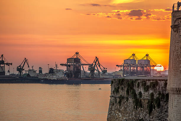 Taranto, Puglia, Italy Sunset in Taranto from Aragonese Castle, the main fortification of the city of Taranto, also called Castel Sant'Angelo. taranto stock pictures, royalty-free photos & images