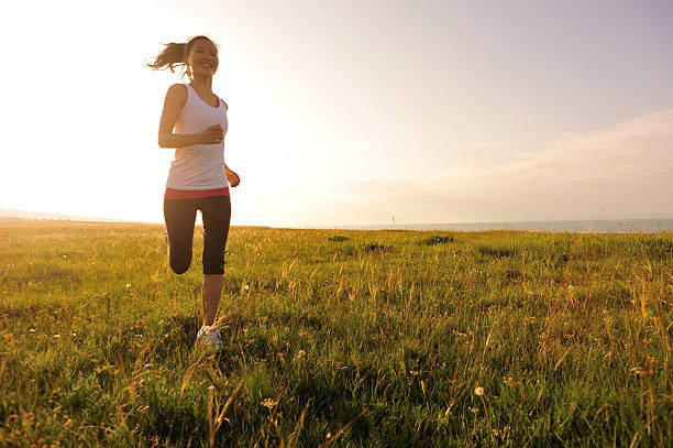 istock Runner athlete running on sunrise/sunset grass field 509030711