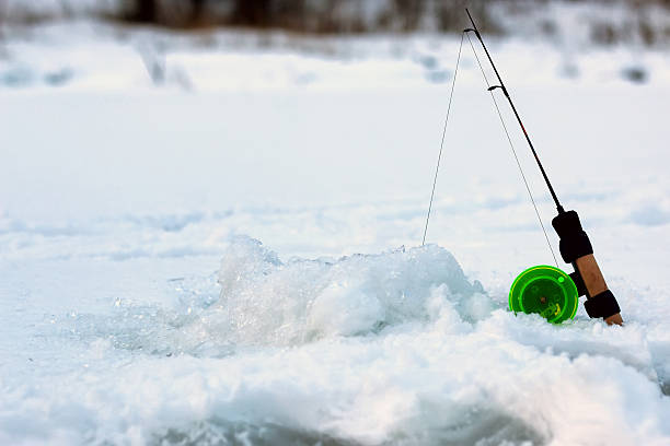 istock Little winter fishing rod ice 509031420