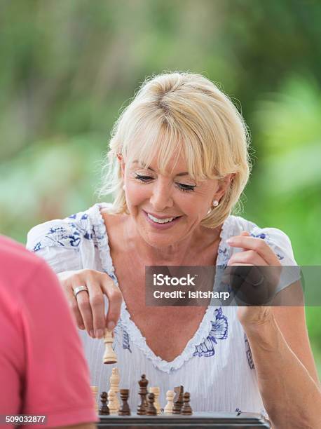 Senior Woman Playing Chess Stock Photo - Download Image Now - Active Lifestyle, Active Seniors, Adult