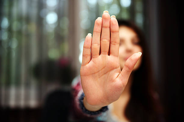 istock Woman with her hand extended signaling to stop 509034743