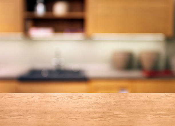 istock Wooden desk detail with blurred kitchen background, home interior 509036108