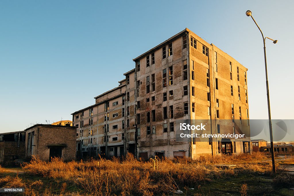 Old obsolete industrial building ruined and ready for demolishin Old obsolete industrial building ruined and ready for demolishing, wide angle shot of abandoned factory construction. Abandoned Stock Photo